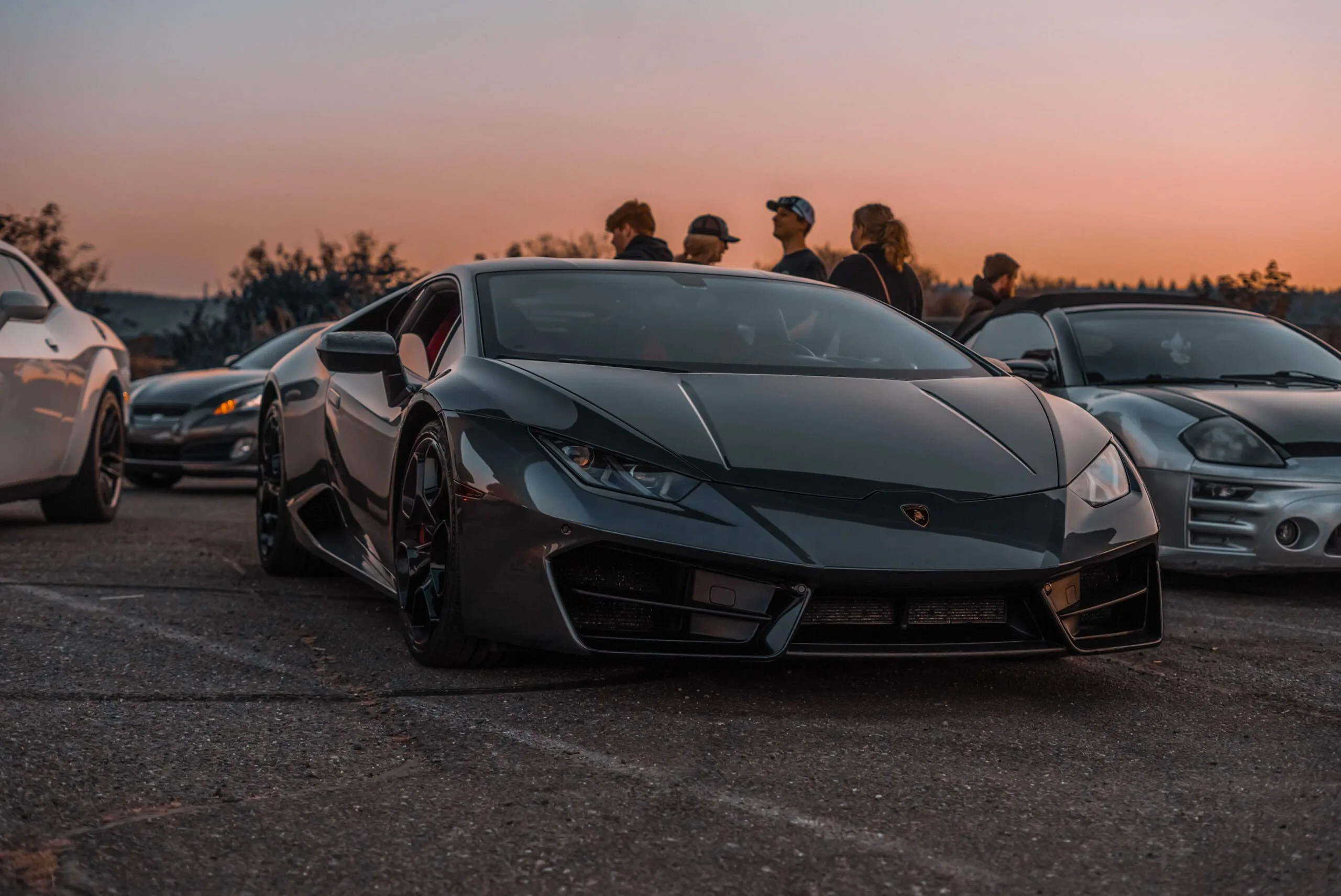 Exotic cars lined up at dusk